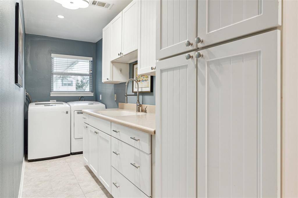 Off the garage entry, the laundry/mudroom adds wonderful convenience with extensive storage, a sink, and a side-by-side LG washer-dryer.