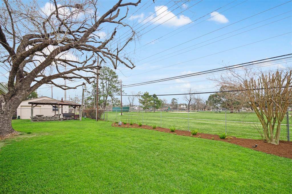 The fully fenced yard provides a safe space for pets and play, while a convenient gate opens directly to Jaycee Park.