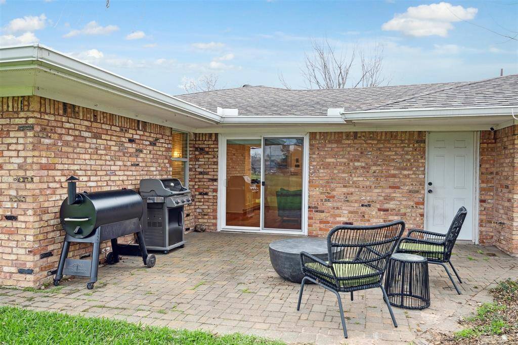 Outdoor entertaining is irresistible thanks to the large brick patio accessible from both the living room sliders and a separate door off the mudroom.