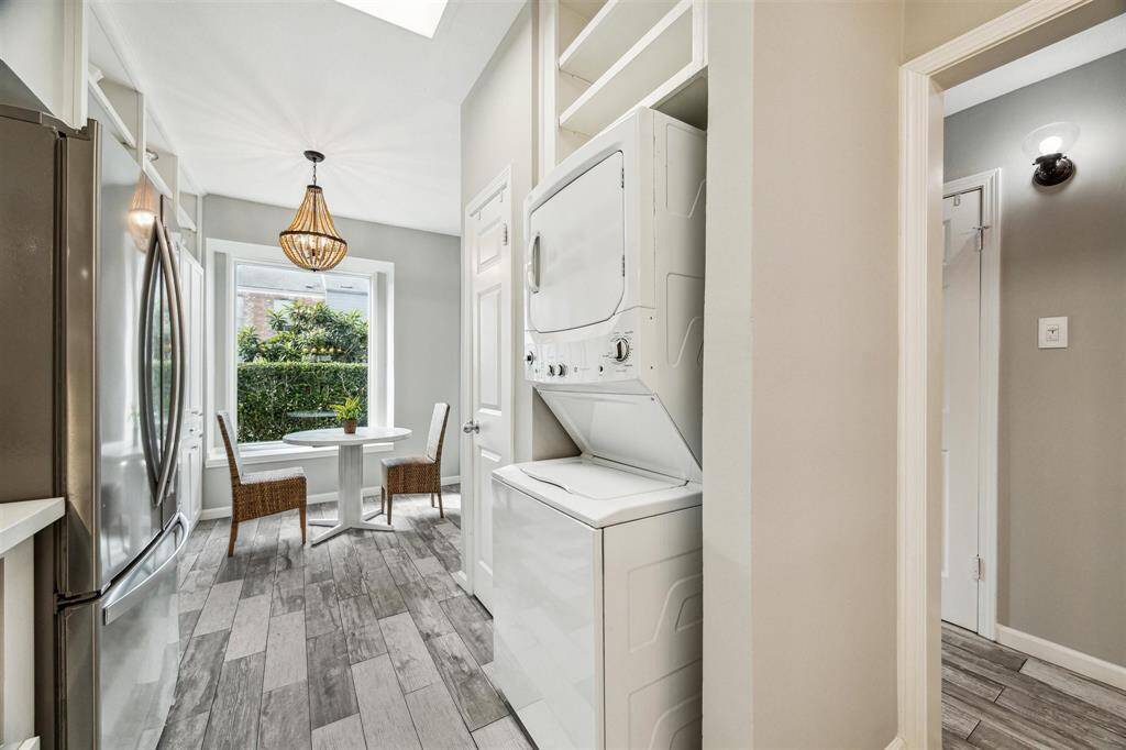 The kitchen flows seamlessly into the breakfast room, beautifully enhanced by a large window that lets in natural light.