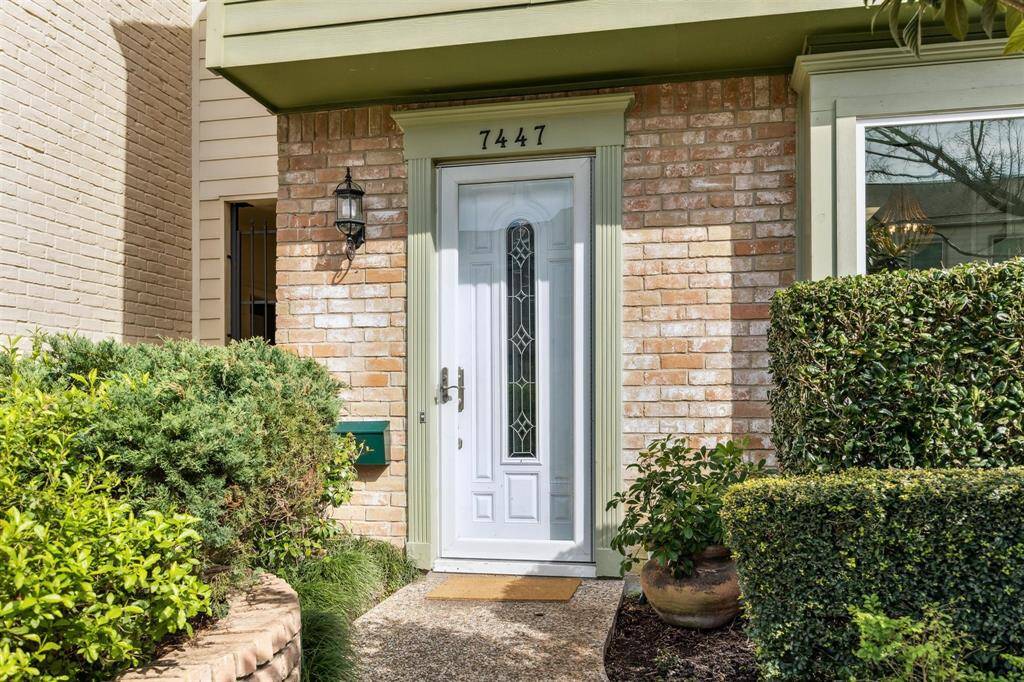 The welcoming entrance is framed by well-maintained landscaping, which also highlights the charming front window.