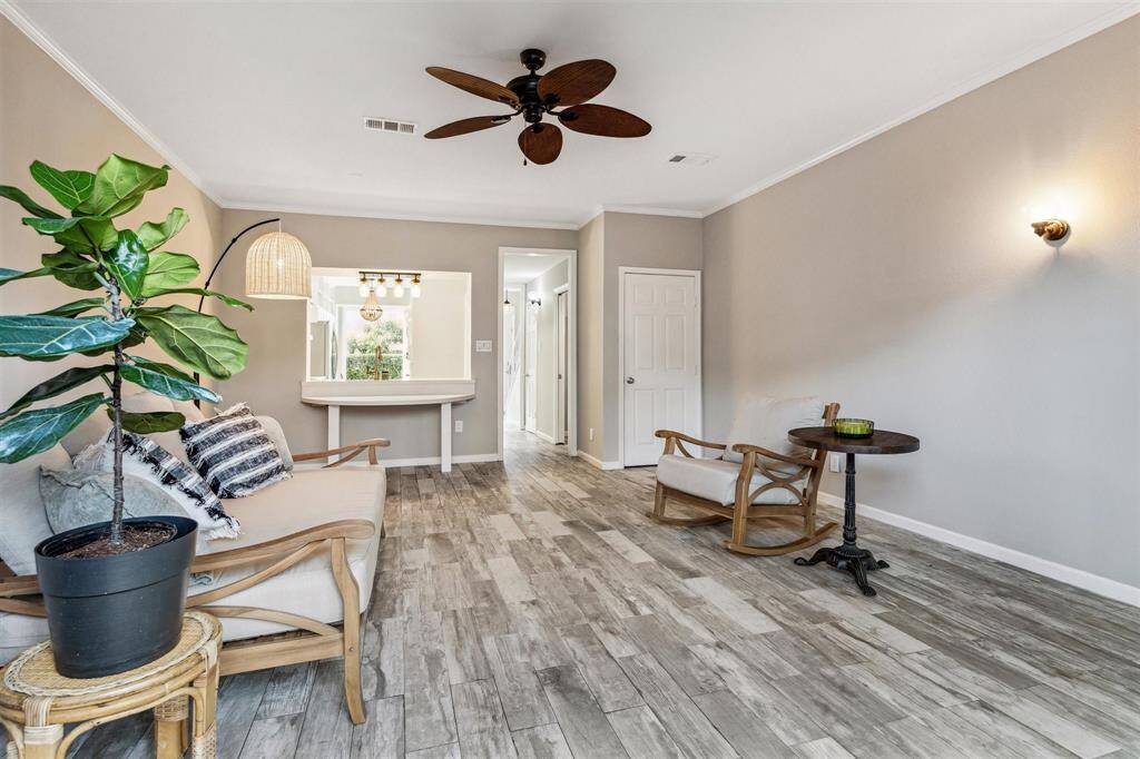Alternate view of the large living room showcasing the gorgeous laminate flooring.