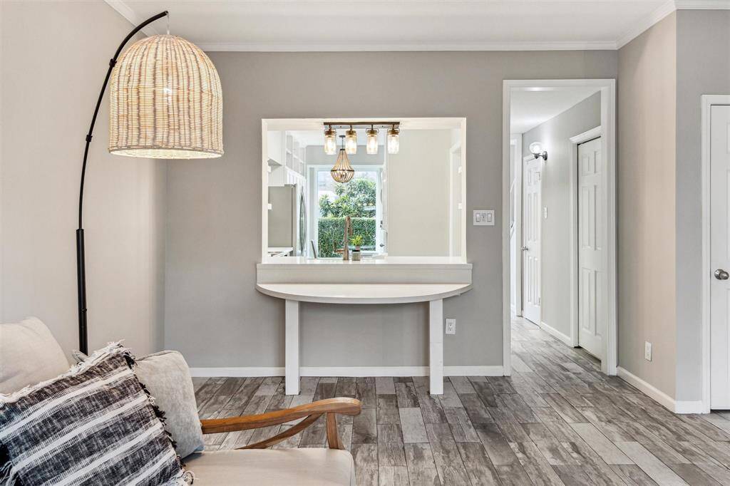 The open flow of the home brings each room together seamlessly. Tucked under the window is a nice table area, great for dining or studying.