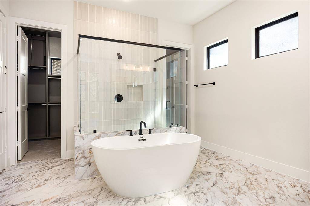 Primary Bathroom with separate walk in shower and soaking tub