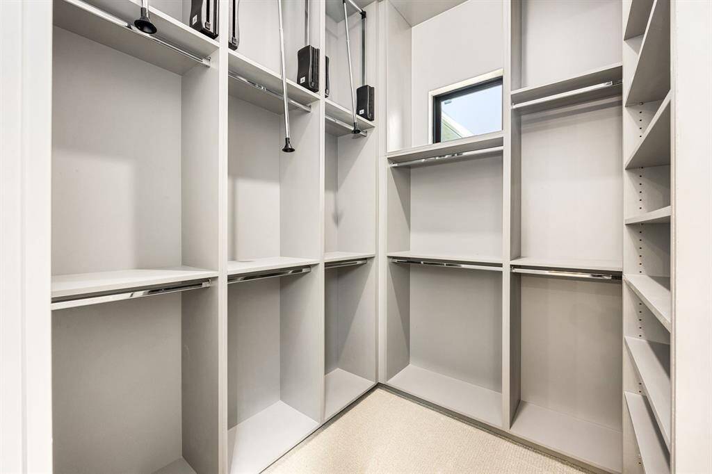Primary Walk In Closet with maximizing storage from floor to ceiling