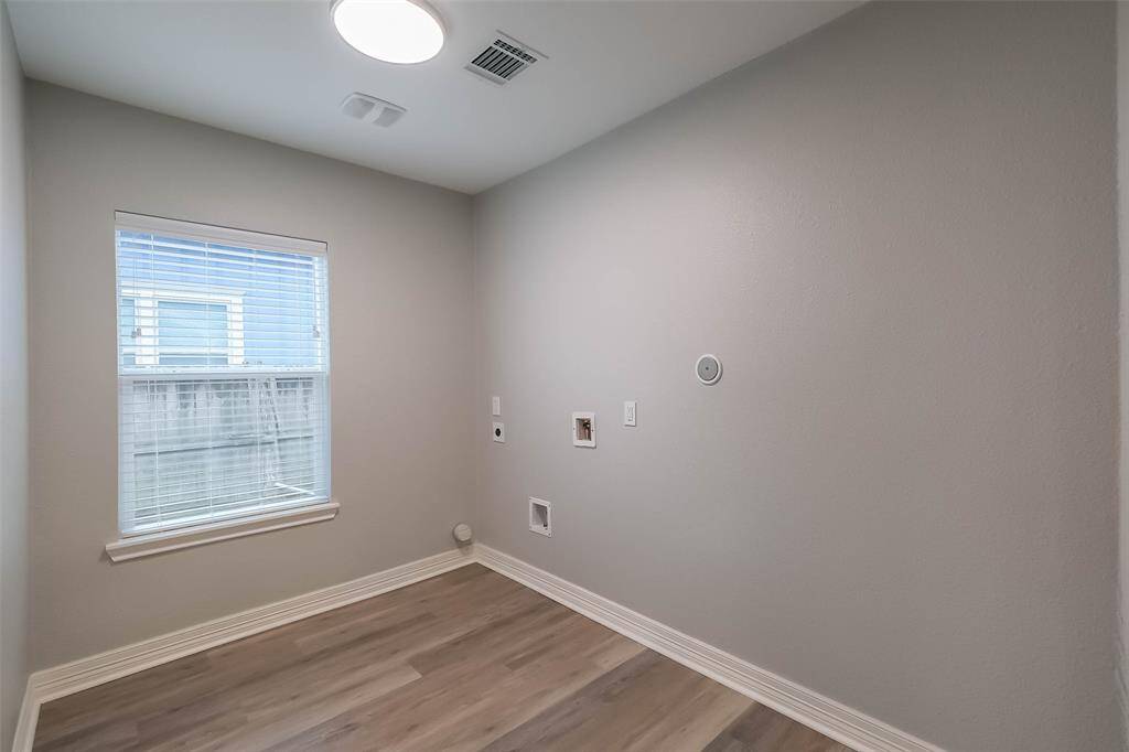 The laundry room is spacious and has ample room for storage!