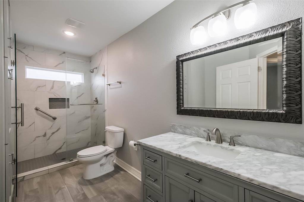 The bathroom has been update to include built-in cabinets, a large seamless glass shower, and oversized vanity!