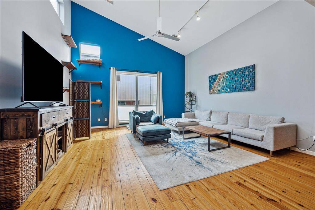 Note the high ceiling in the living area and all the windows for natural light.