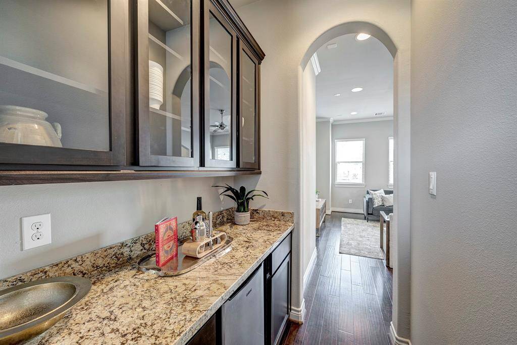 Butler's pantry off the living area with glass front cabinets to display your wares, beverage center and extra storage.