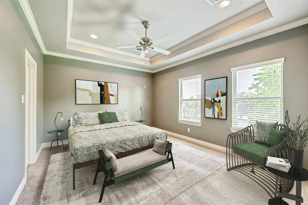 Upstairs primary bedroom with tray ceiling, wired for sound and walk-in closet. (virtually staged)