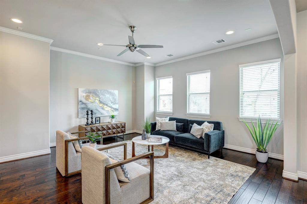Living area with filtered light through the window treatments. Surround sound wiring in place.