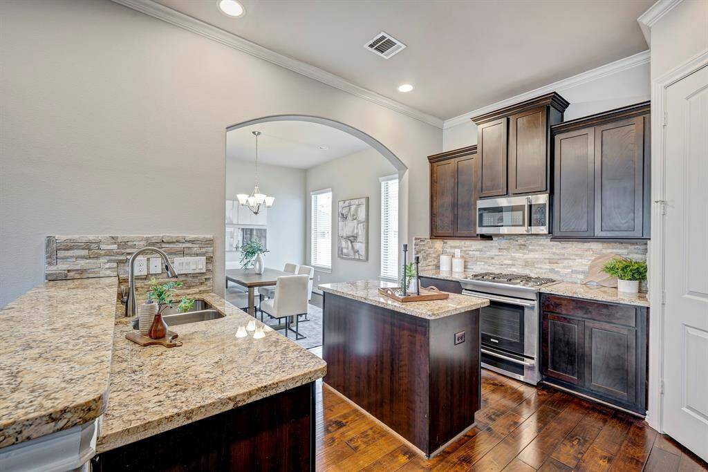 Gorgeous kitchen offers granite counters, stainless steel appliances and walk-in pantry.