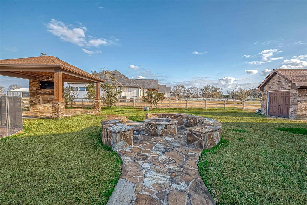 Fabulous fire pit with bench seating. Perfect for those cool Texas evenings gazing at the stars!