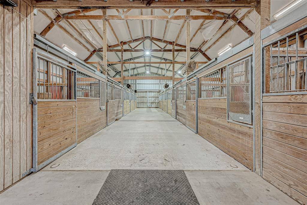This is a horse lovers dream barn!!  There is (12) 12x12 stalls or you can easily convert (4) stalls into 24x12 and still have (8) 12x12 stalls. Includes a tack room, hay storage, loft area for additional storage and is complete with extensive lighting, fans, and feeders.