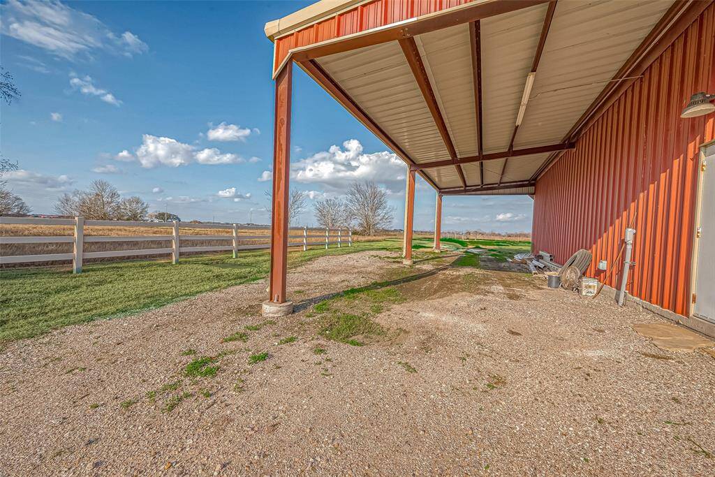 Extended lean to off shop provides additional parking for trailers, equipment, boat or RV.
