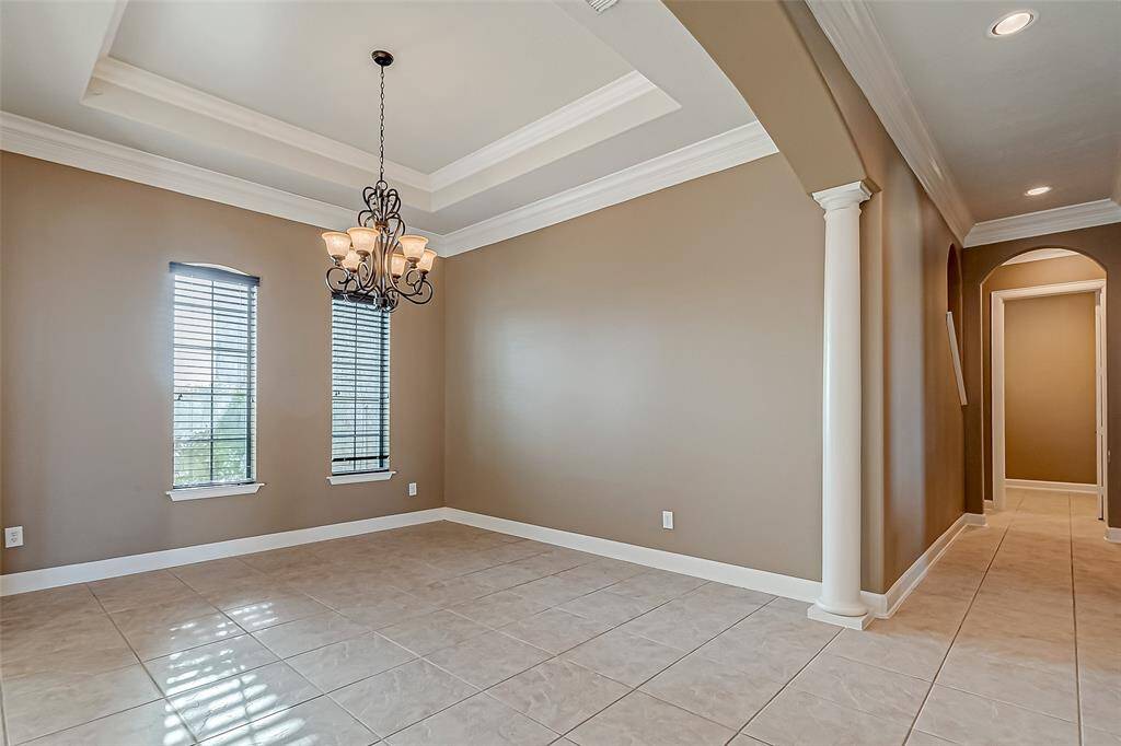 Formal dining room with double tray ceilings.