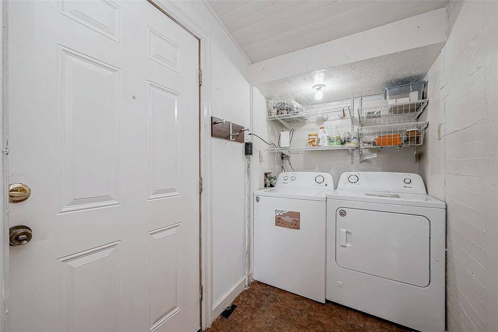 Laundry room w 2 full size washer/dryers included in sale.