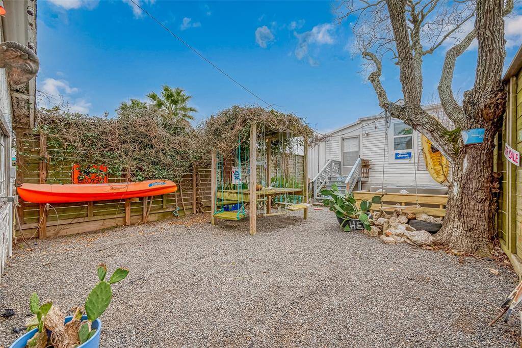 Black star gravel, cacti & rosemary bushes are the low maintenance an artist has the time to focus on. Kayaks for decor only.
