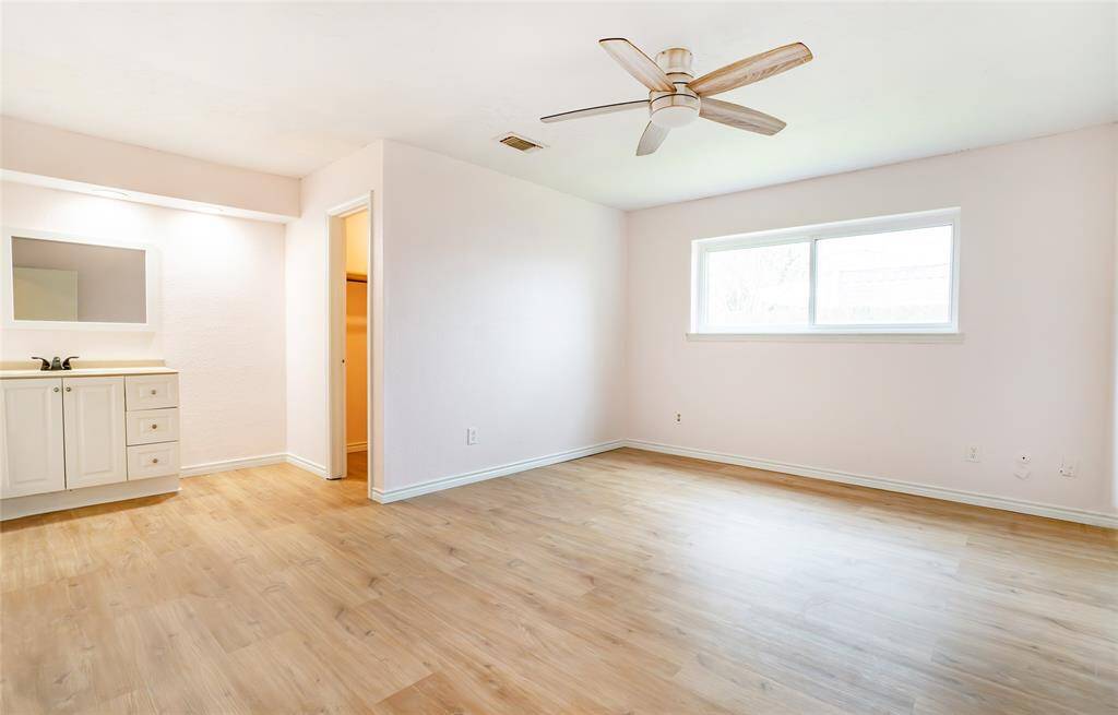 The large primary bedroom with new flooring is a clean slate for your designer touch.