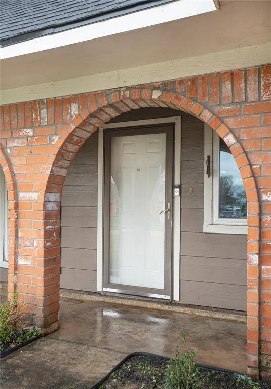 The arched brick front porch is waiting for you to come inside and make this home your very own.
