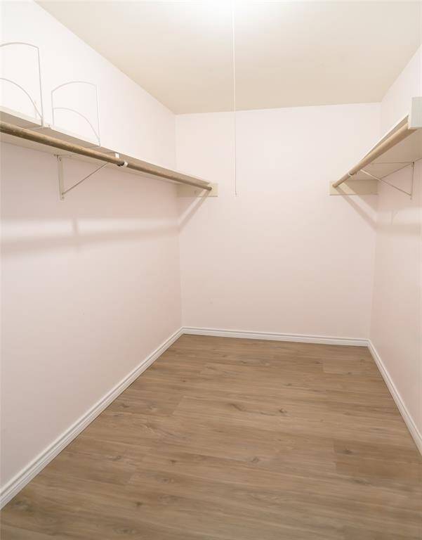 The primary walk-in closet with shelving.