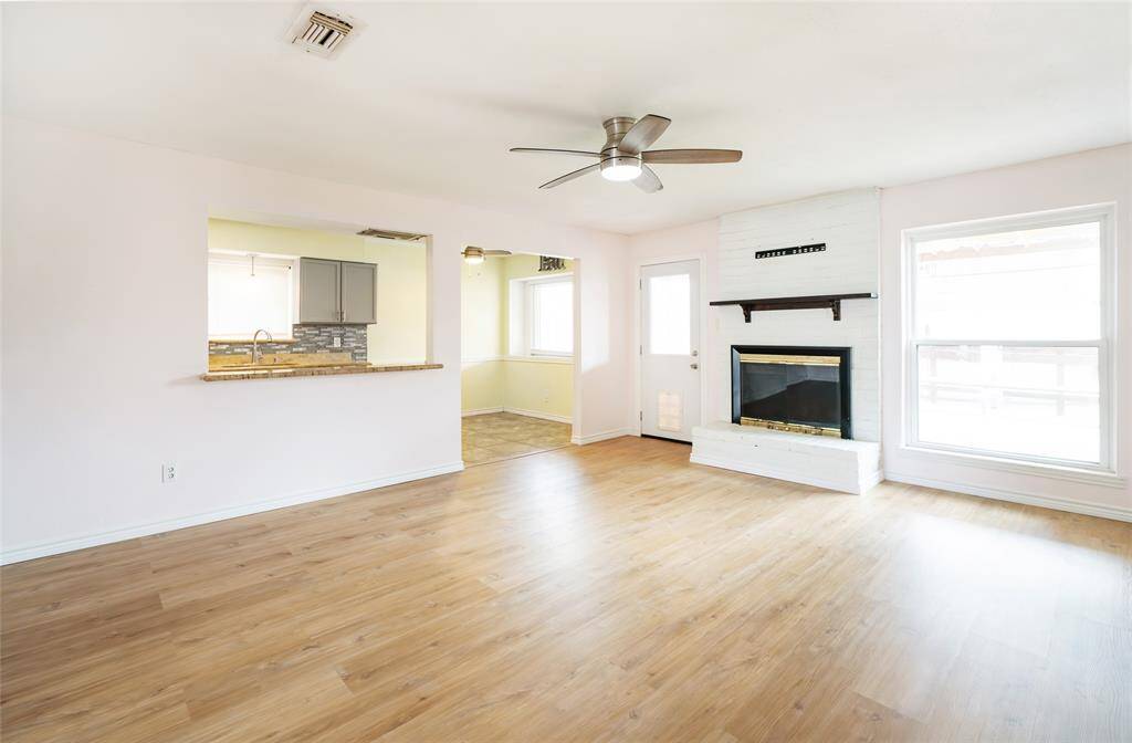 Enter into the spacious living area with new vinyl plank flooring, double hung windows and fresh paint.