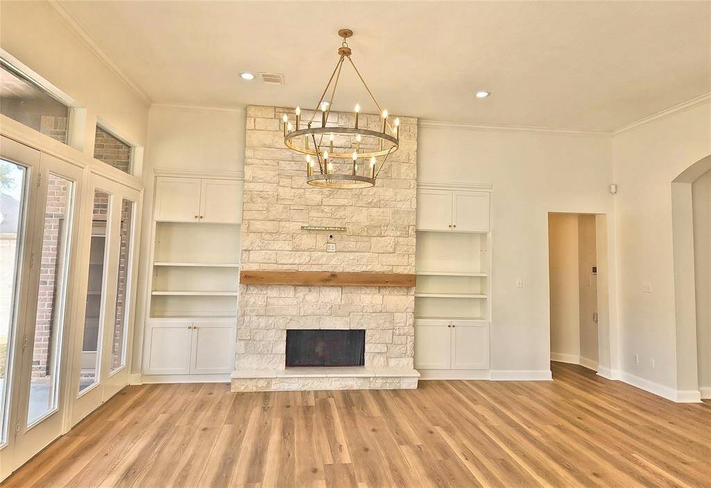 Limestone Stacked Fireplace Accompanied by Built-ins