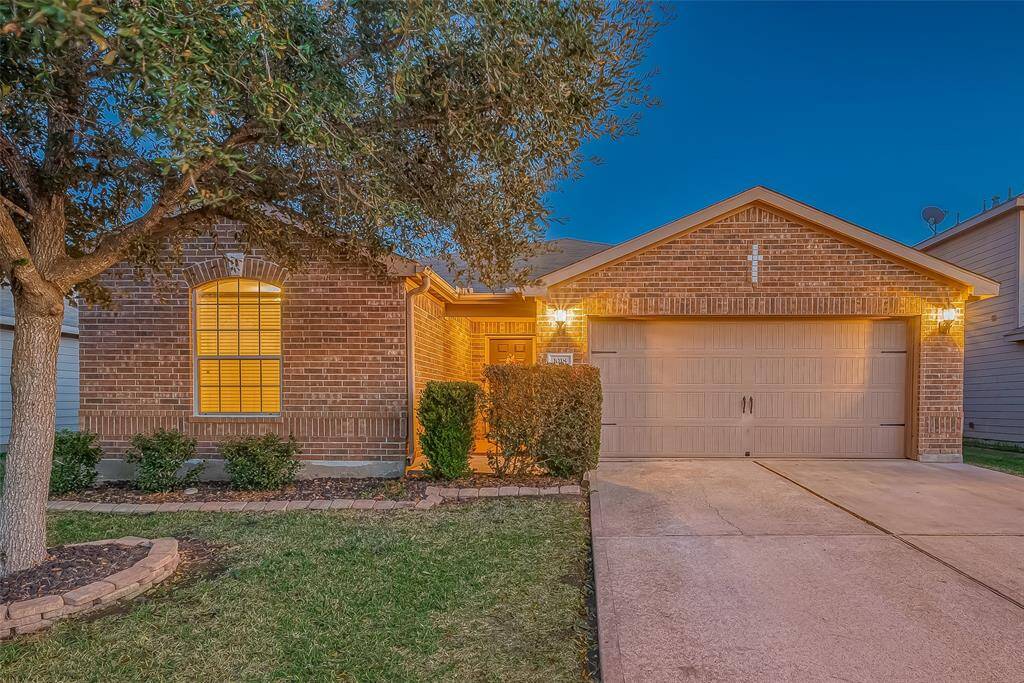 Come and see this inviting brick home that has a warmly lit entrance, offering a cozy and welcoming atmosphere.