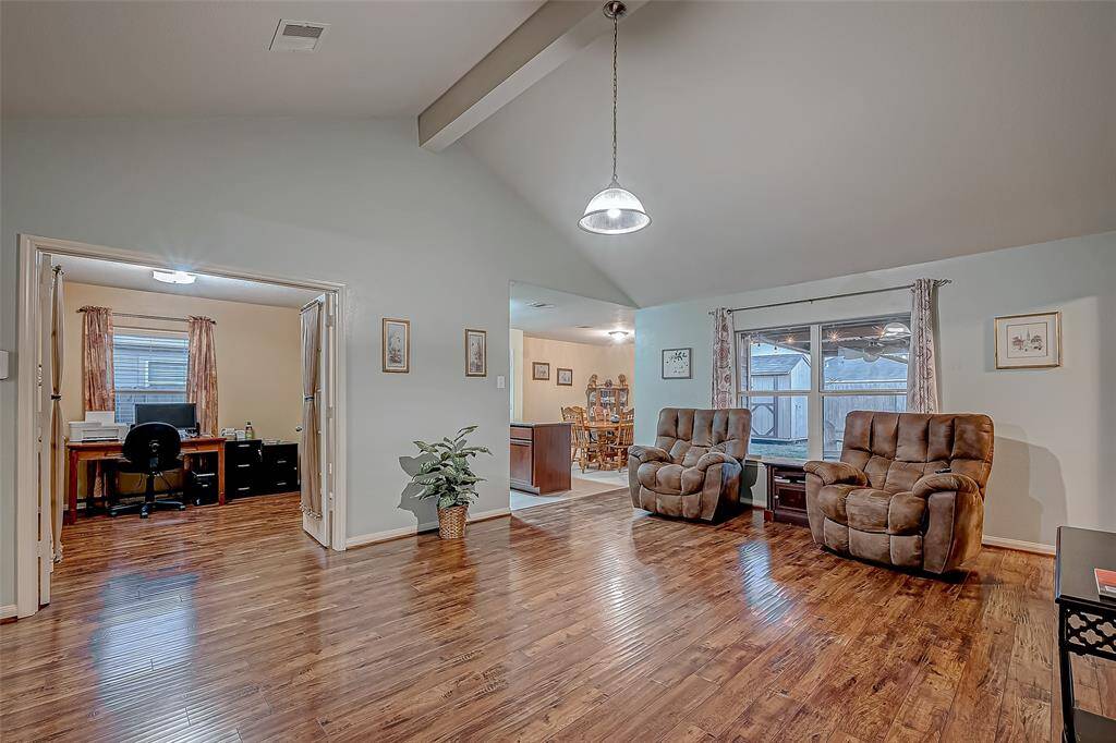 The living area opens into a cozy office space and the kitchen / dining area, creating a versatile and inviting environment for work and relaxation.