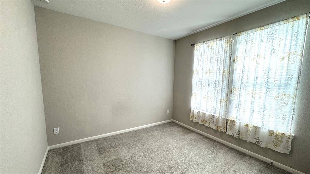 Overlooking the front yard, is the third bedroom.