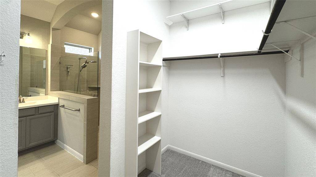 Built-in storage and additional shelving in the primary closet - so helpful!