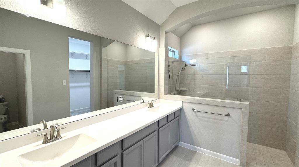 Wow! You have ample space to prepare for your day. Check out the super shower and lower cabinet storage!