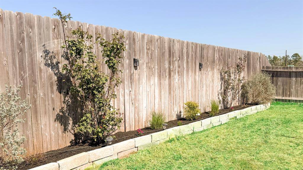 Texas sage, Peace roses, pink Muhly grass, marigolds, dianthus and sunshine Ligustrum create a gorgeous pollinator garden that attracts hummingbirds, butterflies and bees through their blooming season.