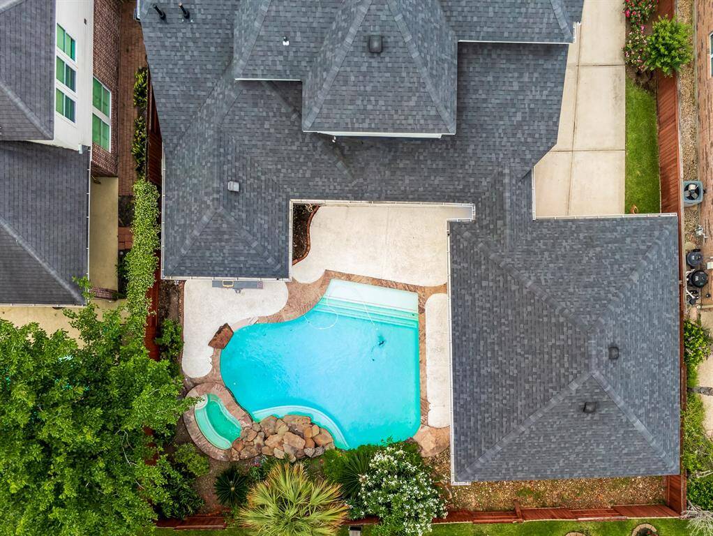 Experience luxury living in this stunning home featuring a sparkling pool, beautifully integrated with a spacious patio for ultimate relaxation and entertainment. Surrounded by lush greenery for added privacy, this property promises a serene oasis right in your backyard.