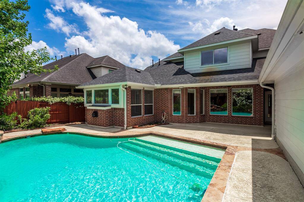 This stunning home features a sparkling pool and spacious patio, perfect for entertaining. Enjoy modern design with ample natural light and a serene outdoor oasis.