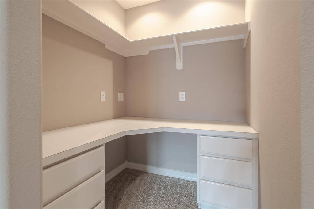 Discover a versatile nook perfect for a home office or creative workspace. This area features built-in shelving and drawers, offering ample storage and organization. Ideal for maximizing productivity in a cozy setting.