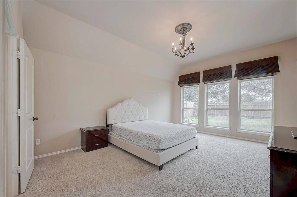 Spacious primary bedroom with plenty of natural lighting.