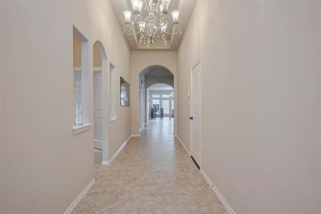 Inviting foyer with high ceiling.