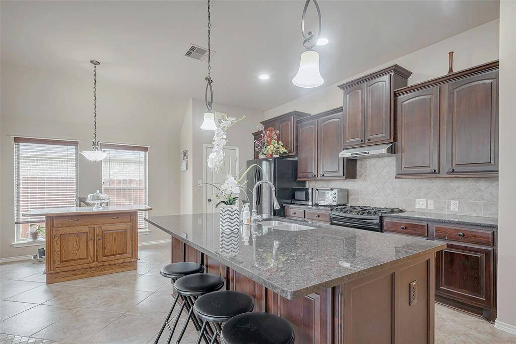 Large kitchen island with ample cabinets. Fridge is included.