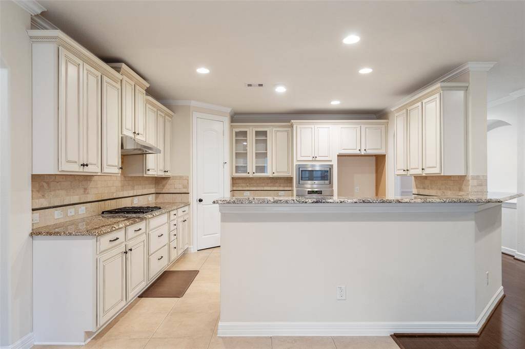View of kitchen and breakfast bar from the breakfast area.