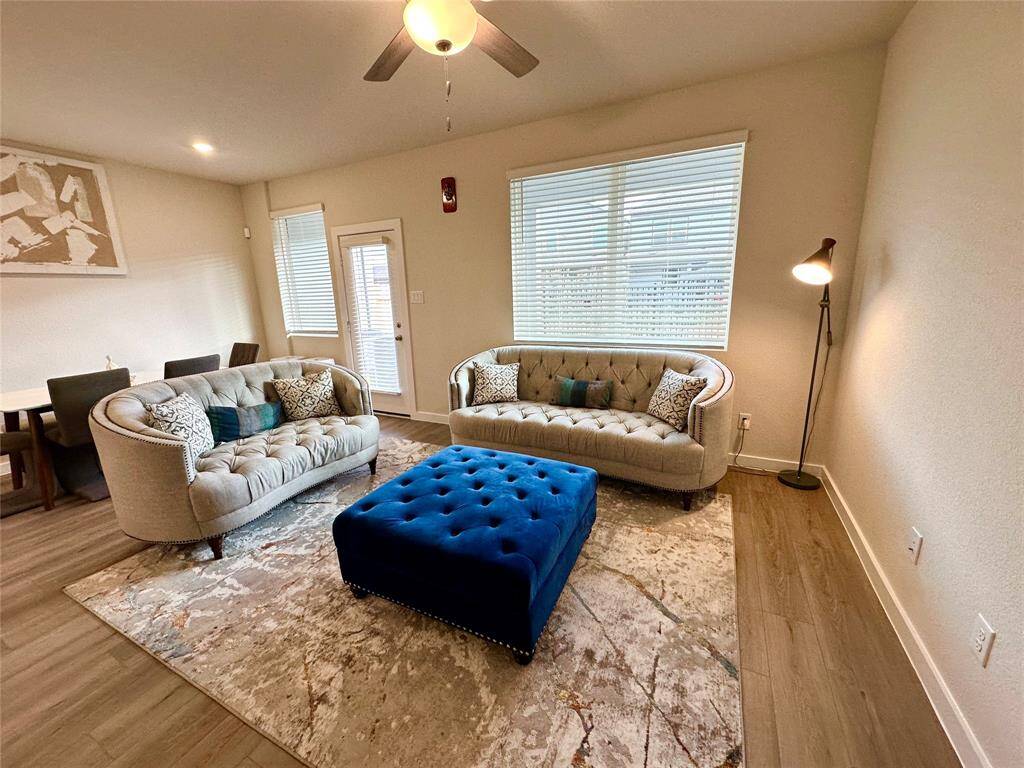 The open layout connects to a dining area, creating a welcoming space for relaxation and entertaining.