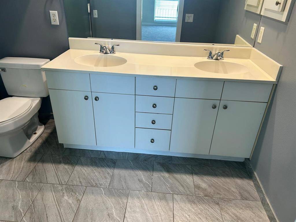 Master bath features all white cultured marble double sinks, large walk in shower and tub withglass enclosure. updated tile flooring. Good undercounter storage.