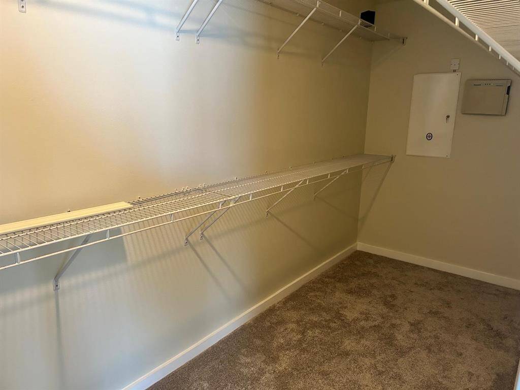 wonderful large walk in closet with shelving.