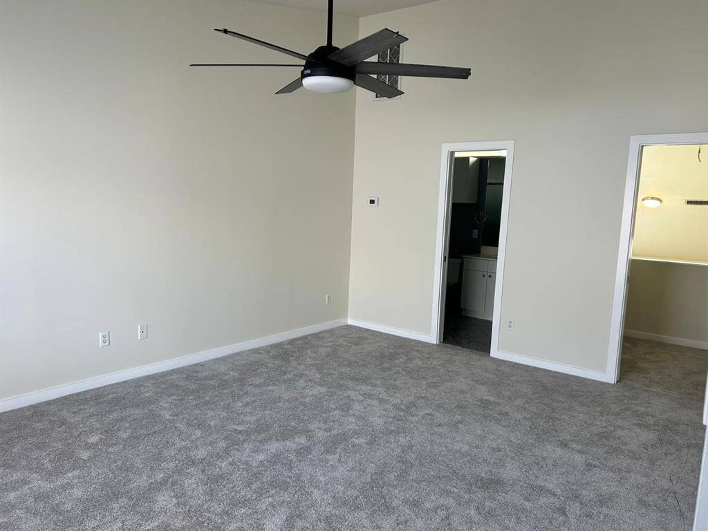 Primary bedroom (17x13) also has high vaulted ceiling, wonderful large walk in closet with shelving, newly installed carpet.