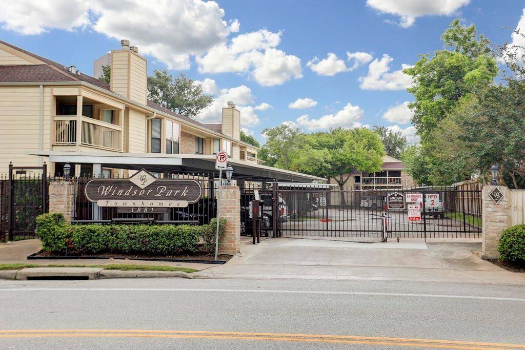 Gated community with security cameras at entrance and exit.