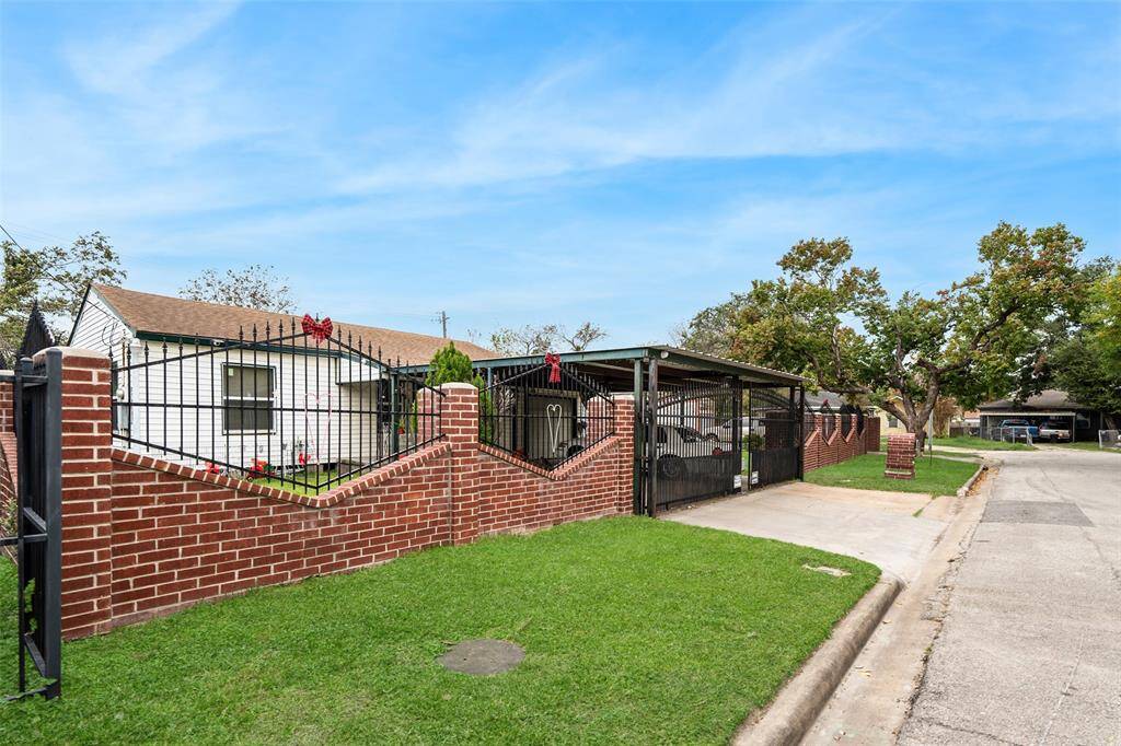Solid brick wall with a sturdy iron gate