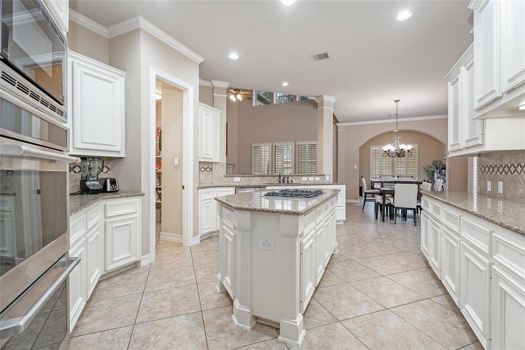 Indulge your culinary passions in this spacious kitchen, featuring ample counter space perfect for entertaining.