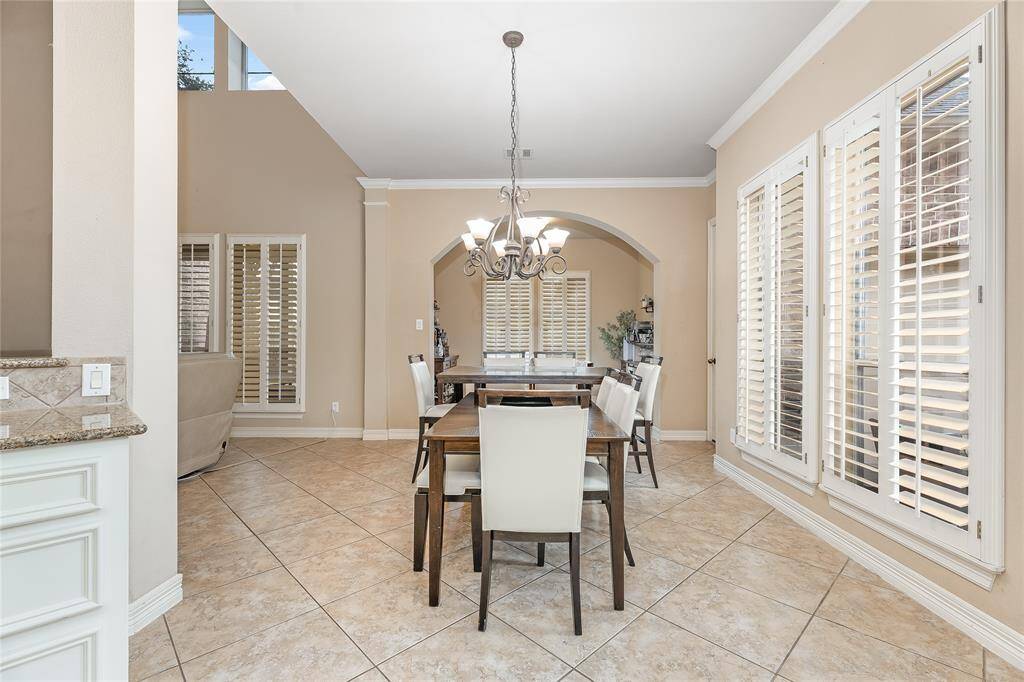 Bright and inviting breakfast area with abundant windows, seamlessly connecting to the family room.