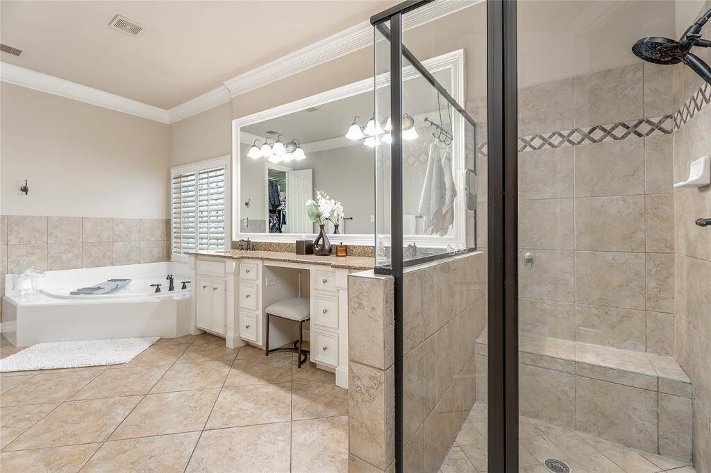 This expansive, spa-like primary bathroom offers the ultimate relaxation experience, perfect for unwinding after a long day.