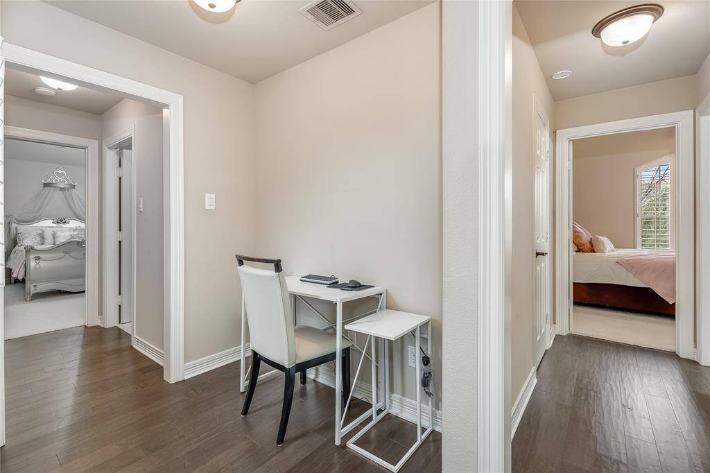 Discover a versatile nook nestled between the spacious secondary bedrooms, perfect for a computer desk or workstation.